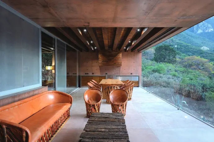 Exterior concrete structure featuring a terracotta-colored architectural ceiling